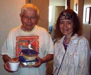 Meals on Wheels client receiving meal from Volunteer Connie 