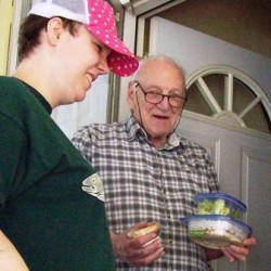 Volunteer Gloria delivering meal to Meals on Wheels client.